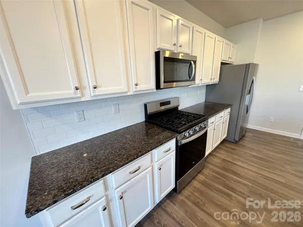 a stove top oven sitting inside of a kitchen