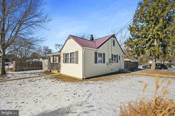 a view of a large house with a yard covered in snow