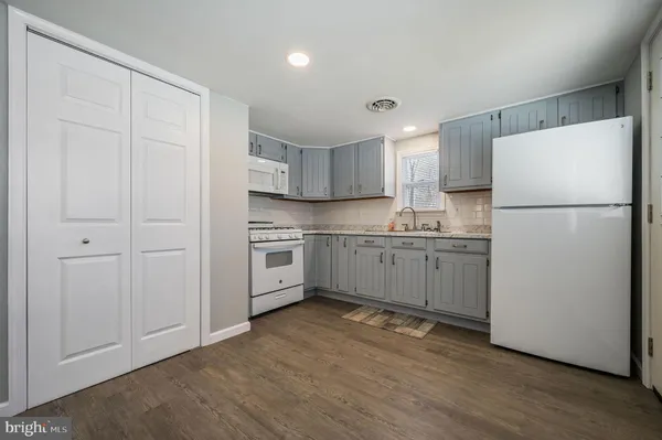 a kitchen with a refrigerator a sink and cabinets