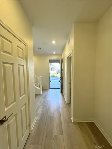 a view of a hallway with wooden floor