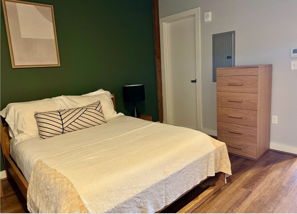 63 Melcher Street, Unit 404 Boston, MA 02210 - Photo 5 of 13 a bedroom with a bed and a window