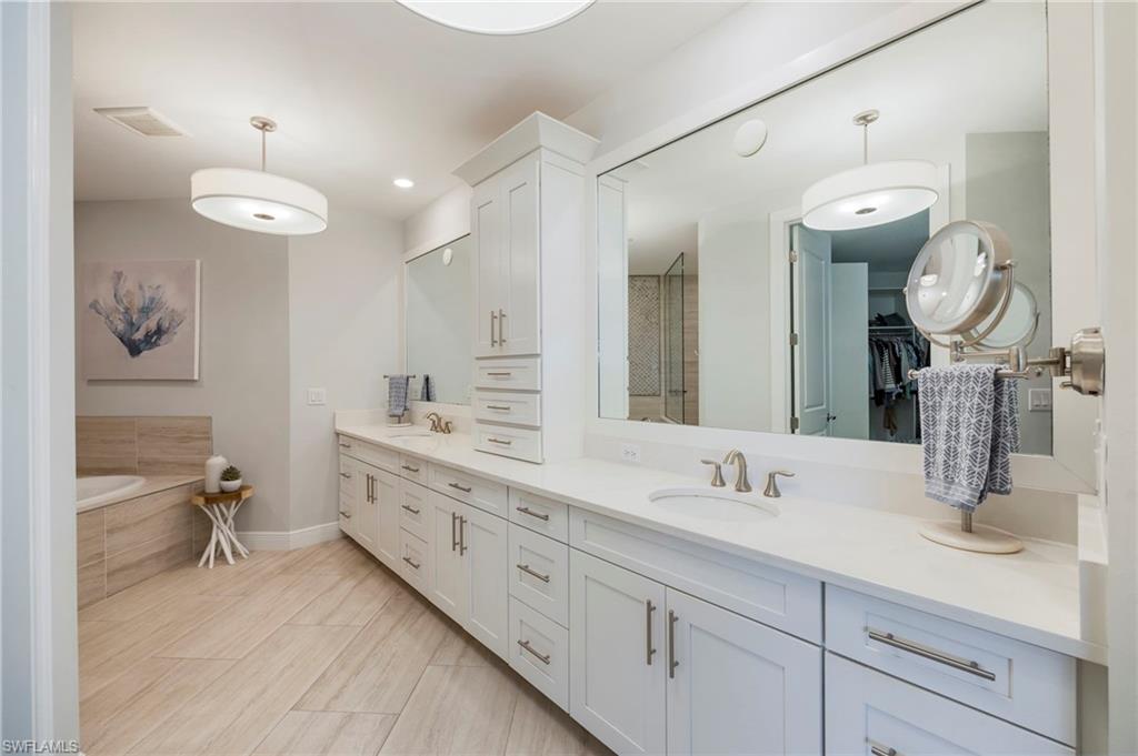 16351 Viansa Way, Unit 202 Naples, FL 34110 - Photo 12 of 35 Full bath featuring double vanity, a walk in closet, a garden tub, and a stall shower
