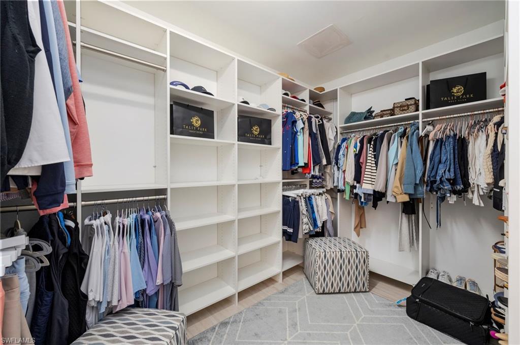 16351 Viansa Way, Unit 202 Naples, FL 34110 - Photo 14 of 35 Walk in closet with attic access and light wood-style flooring