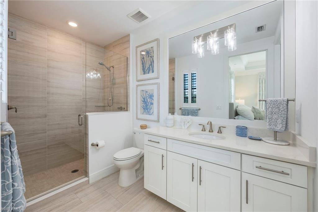 16351 Viansa Way, Unit 202 Naples, FL 34110 - Photo 16 of 35 Ensuite bathroom featuring a shower stall and vanity