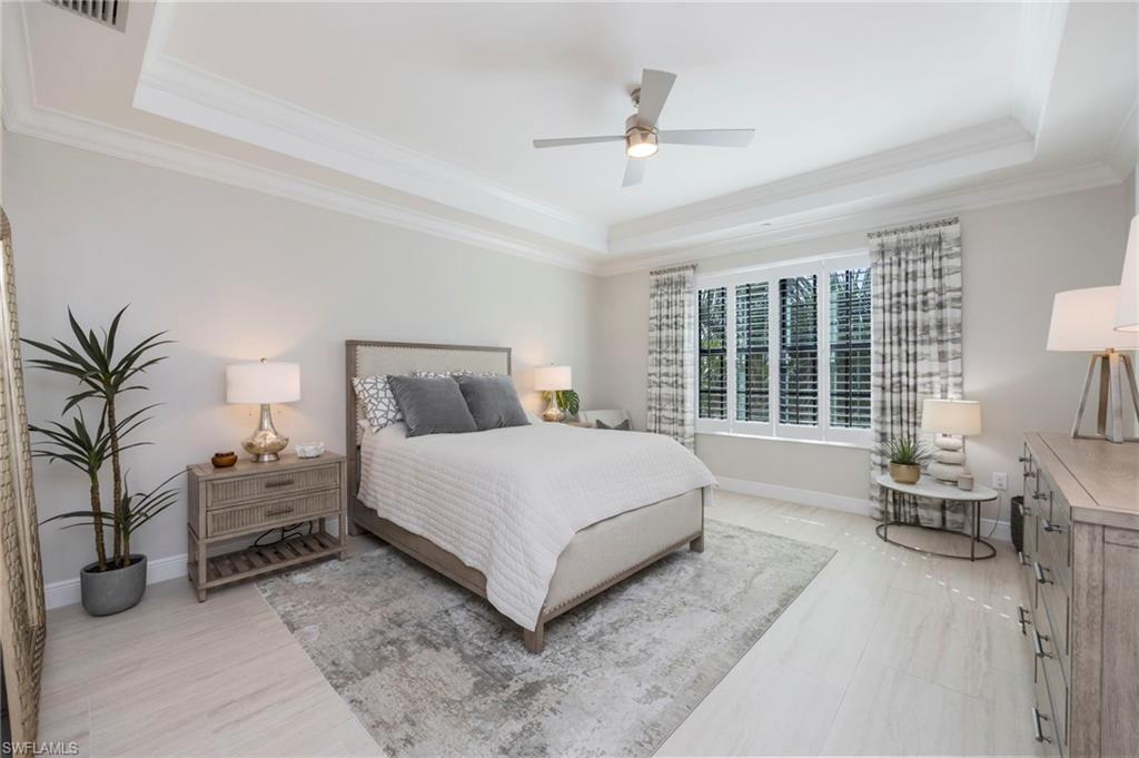 16351 Viansa Way, Unit 202 Naples, FL 34110 - Photo 17 of 35 Bedroom with a ceiling fan, crown molding, and a tray ceiling