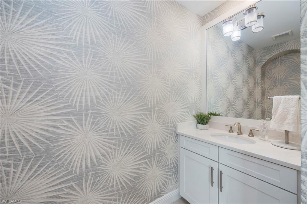 16351 Viansa Way, Unit 202 Naples, FL 34110 - Photo 19 of 35 Bathroom with wallpapered walls and vanity