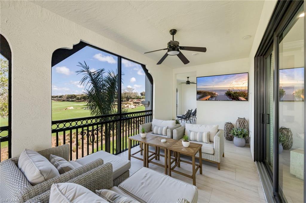 16351 Viansa Way, Unit 202 Naples, FL 34110 - Photo 22 of 35 Sunroom with outdoor seating, a balcony, and ceiling fan