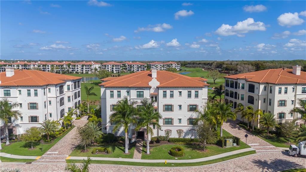 16351 Viansa Way, Unit 202 Naples, FL 34110 - Photo 23 of 35 Aerial view of apartment complex and a large body of water