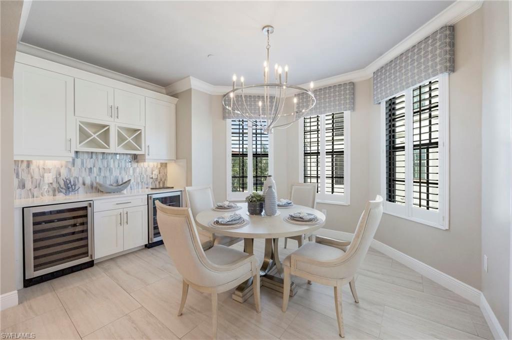 16351 Viansa Way, Unit 202 Naples, FL 34110 - Photo 8 of 35 Dining room with beverage cooler, ornamental molding, suspended lighting, and a dry bar