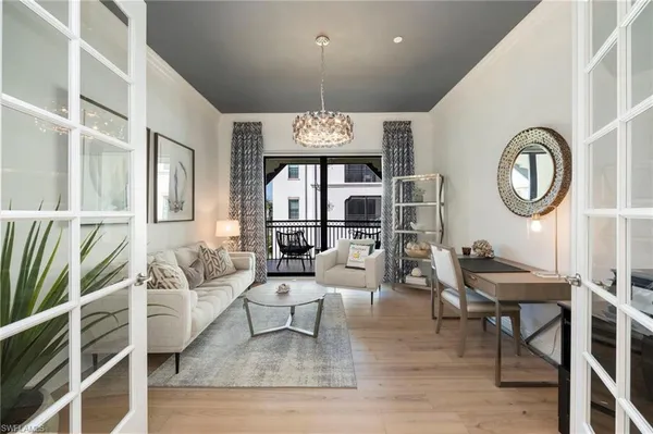 a dining room with a sink dishwasher a dining table and chairs with wooden floor