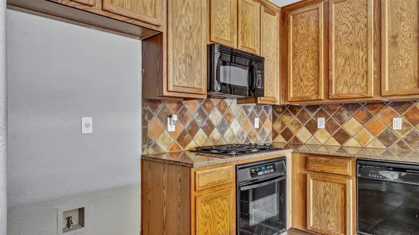 a view of a kitchen with granite countertop cabinets and a fireplace