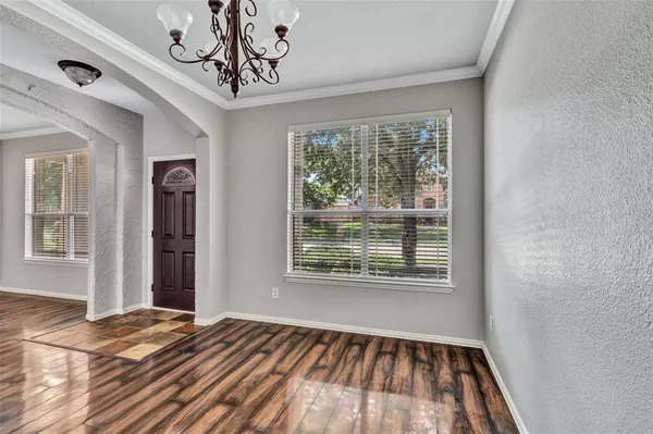 a view of a hallway with entryway wooden floor and front door