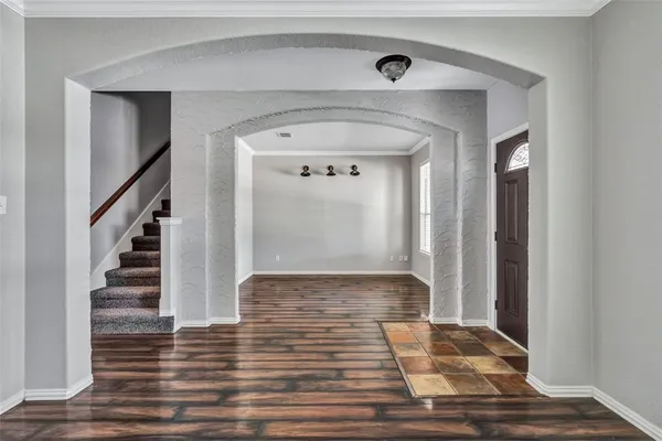 a view of a hallway with wooden floor