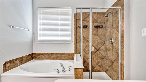 a bathroom with a tub a sink and mirrors
