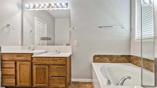 a bathroom with a tub sink and window