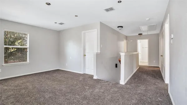 a view of a big room with chandelier fan