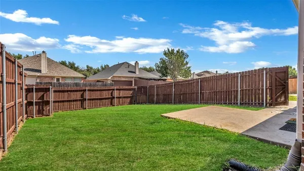 a view of a backyard with a garden and deck
