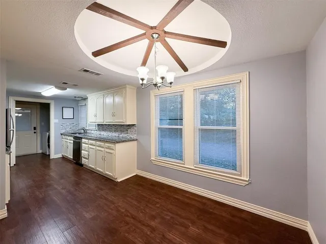 a kitchen with stainless steel appliances granite countertop a stove cabinets and wooden floor