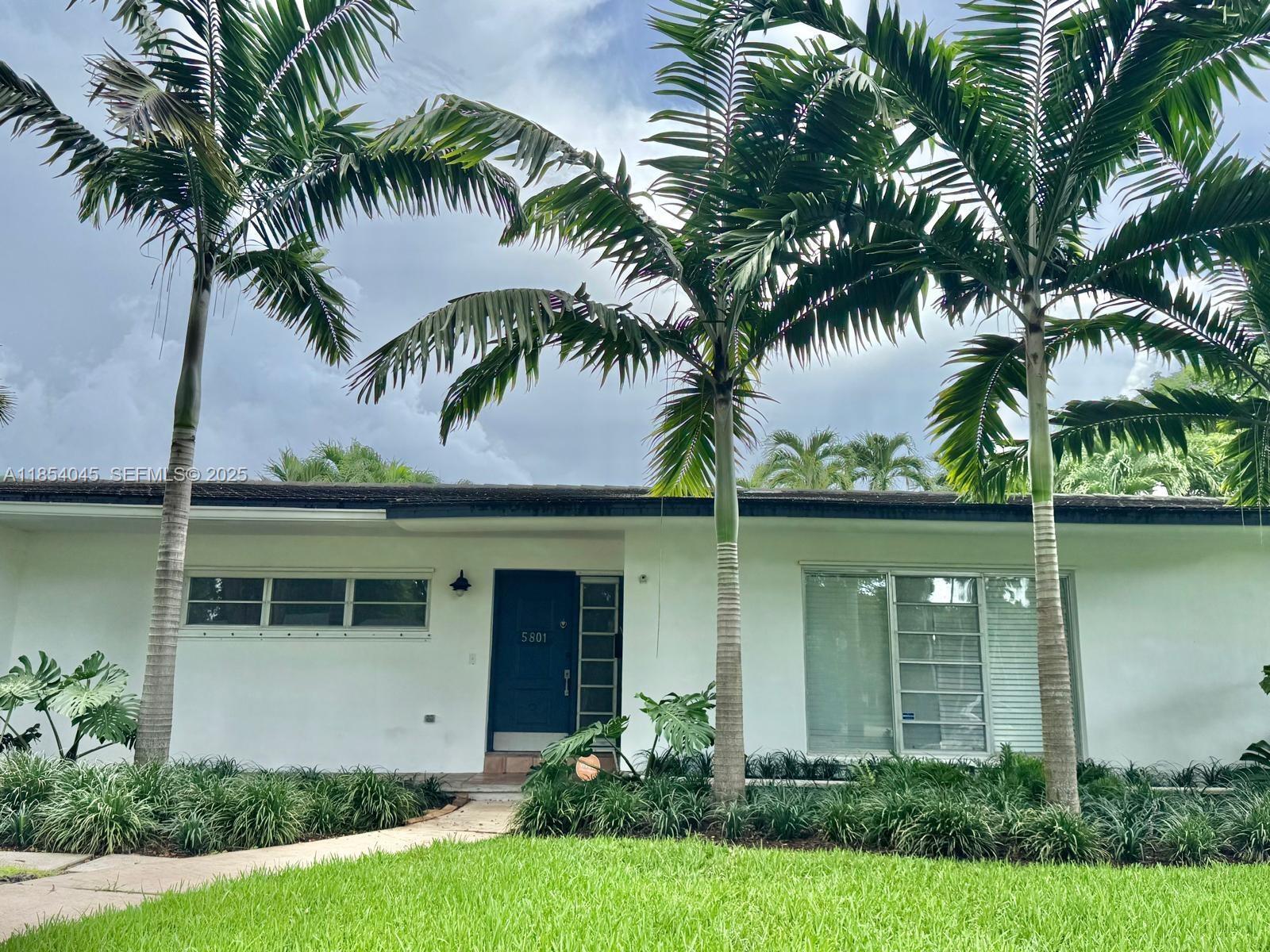 a front view of house with yard and lake view