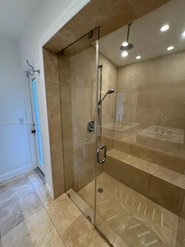 a bathroom with a shower and a mirror