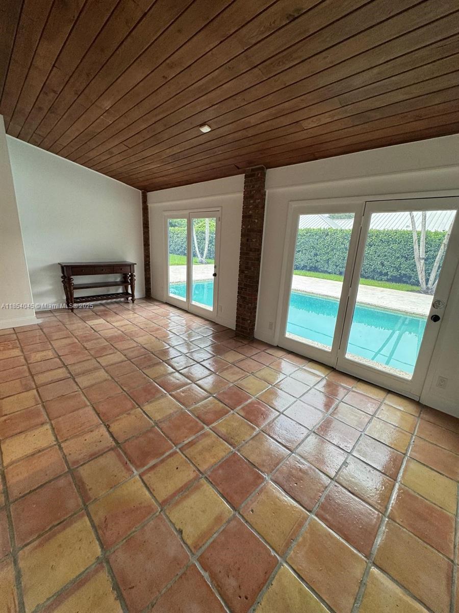 5801 Southwest 100th Street, Unit 1 Pinecrest, FL 33156 - Photo 7 of 11 a view of an empty room with a window