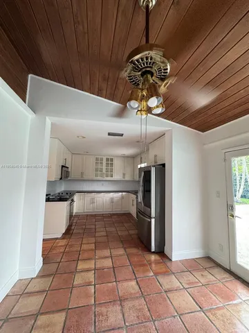 a kitchen with a refrigerator and microwave