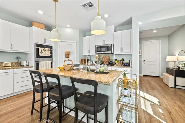 a large kitchen with a table and chairs