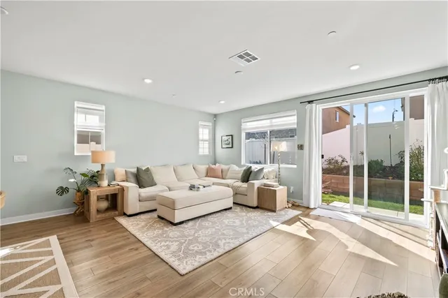 a living room with furniture large window and glass door