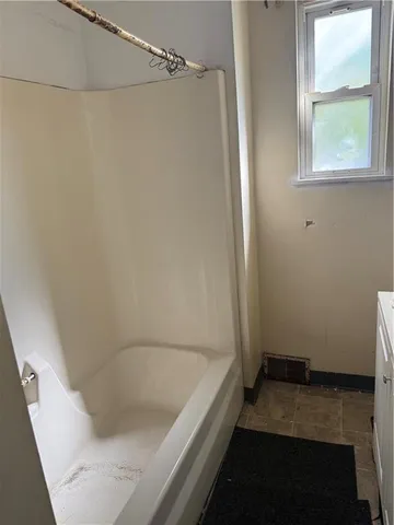 a kitchen with a sink and wooden cabinets