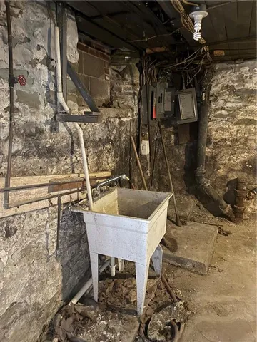 a living room with furniture floor to ceiling window and outdoor view