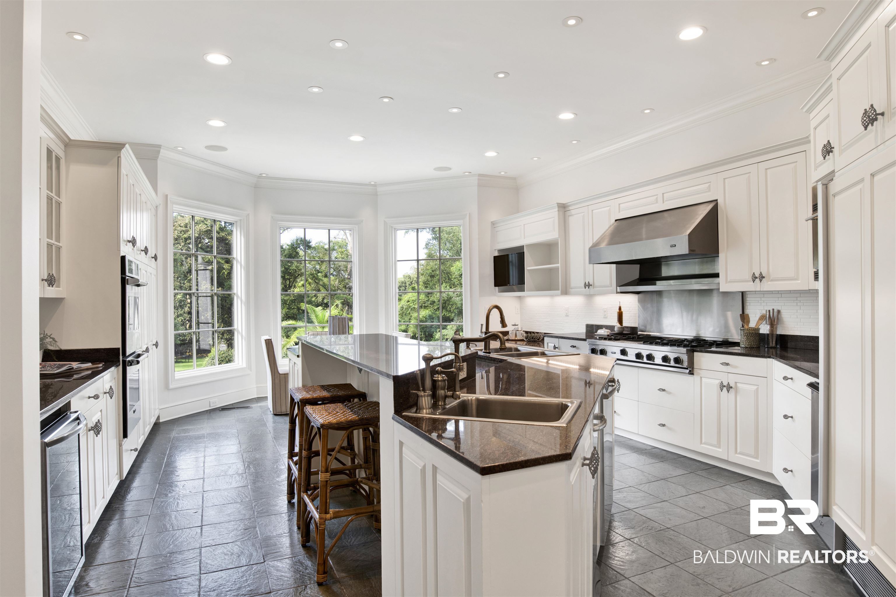 3816 Austill Lane Mobile, AL 36608 - Photo 23 of 80 Kitchen featuring ornamental molding, dark countertops, tasteful backsplash, recessed lighting, and a kitchen island with sink