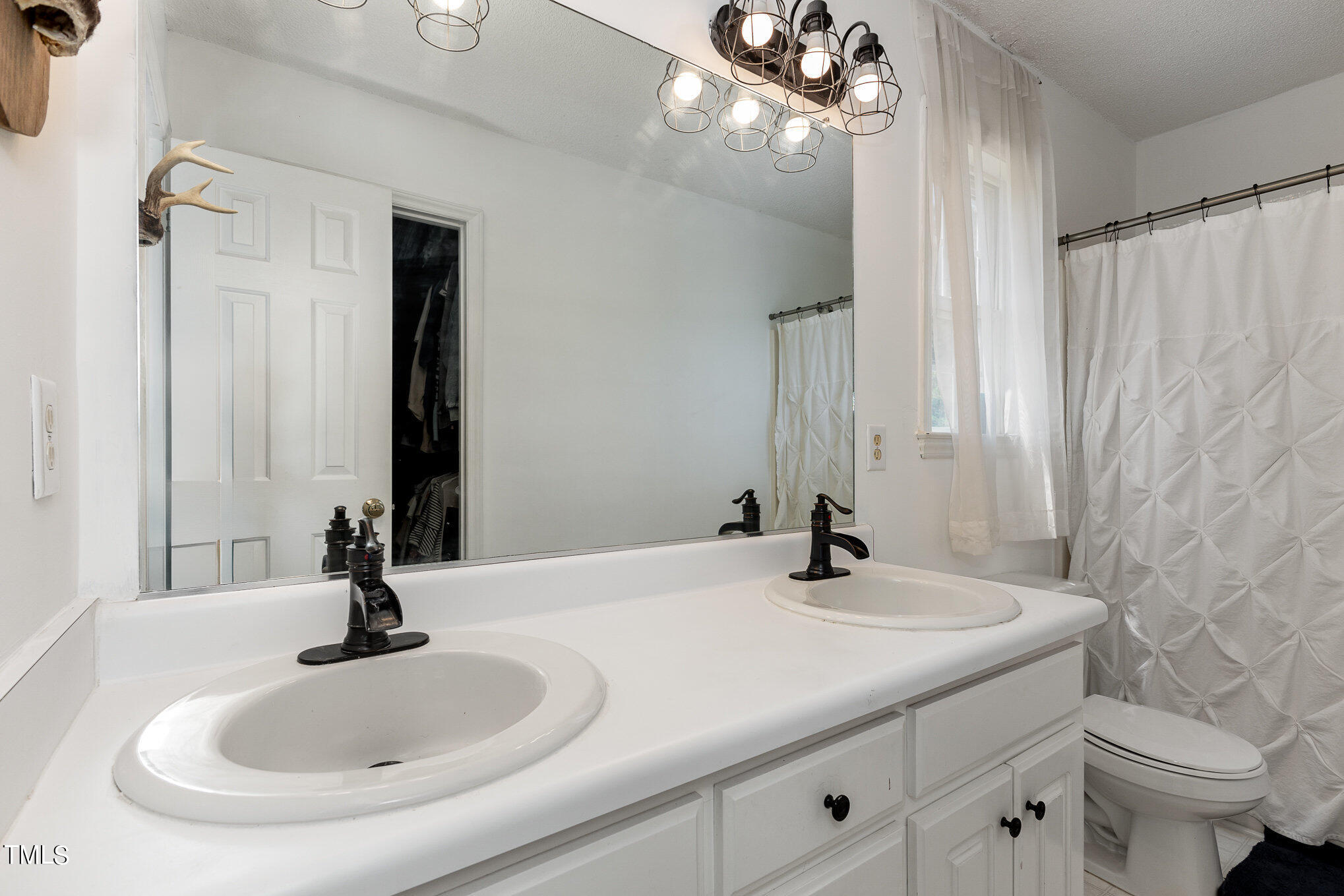 112 Forest Ridge Drive Willow Spring, NC 27592 - Photo 13 of 21 a bathroom with a sink and a mirror