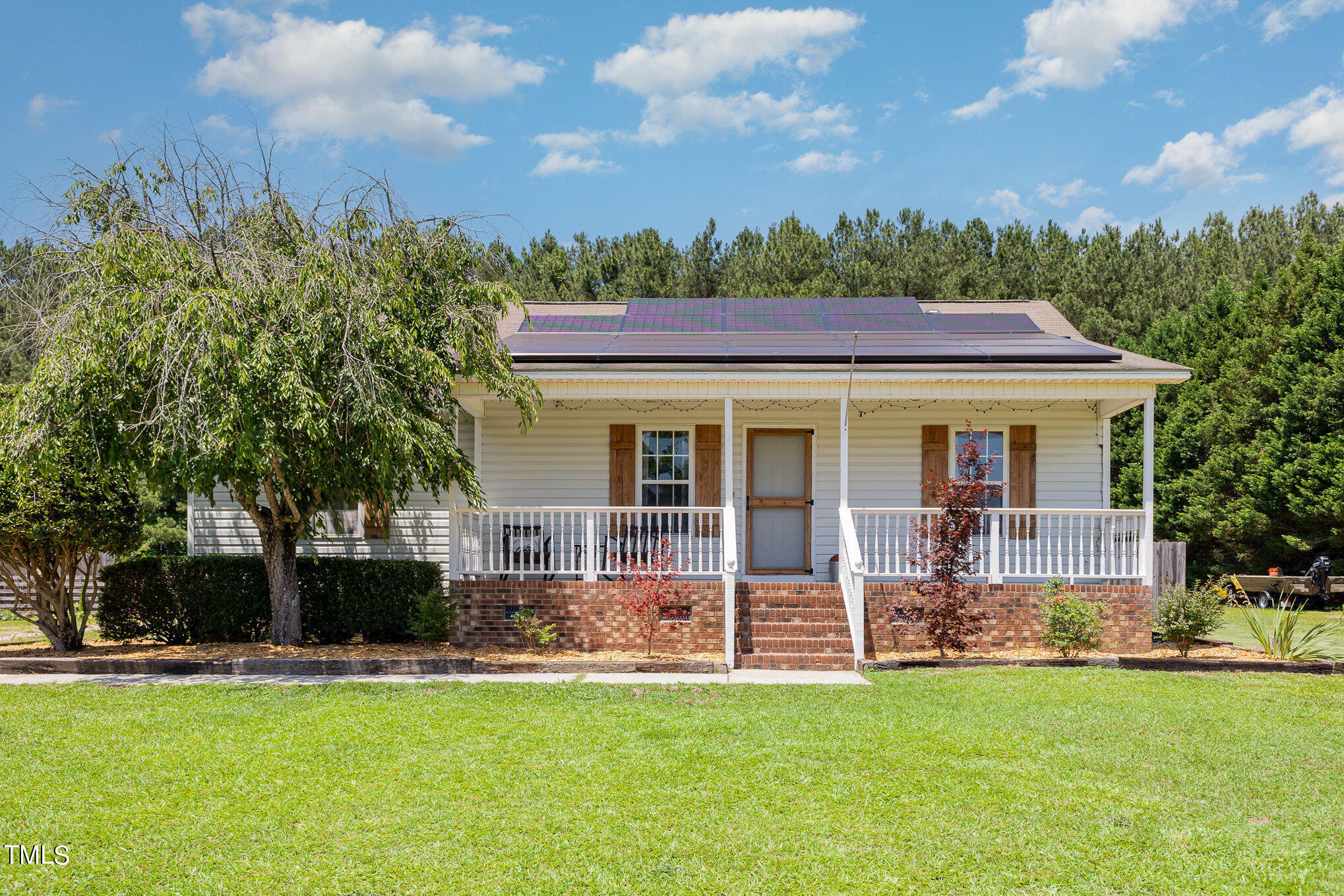 112 Forest Ridge Drive Willow Spring, NC 27592 - Photo 2 of 21 a front view of a house with a garden and trees