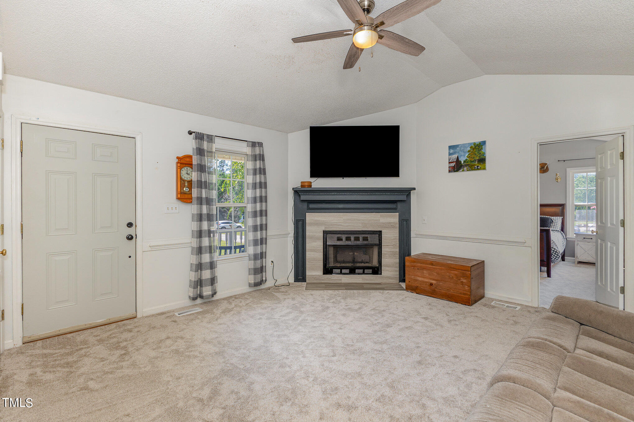 112 Forest Ridge Drive Willow Spring, NC 27592 - Photo 6 of 21 a living room with furniture a flat screen tv and a fireplace