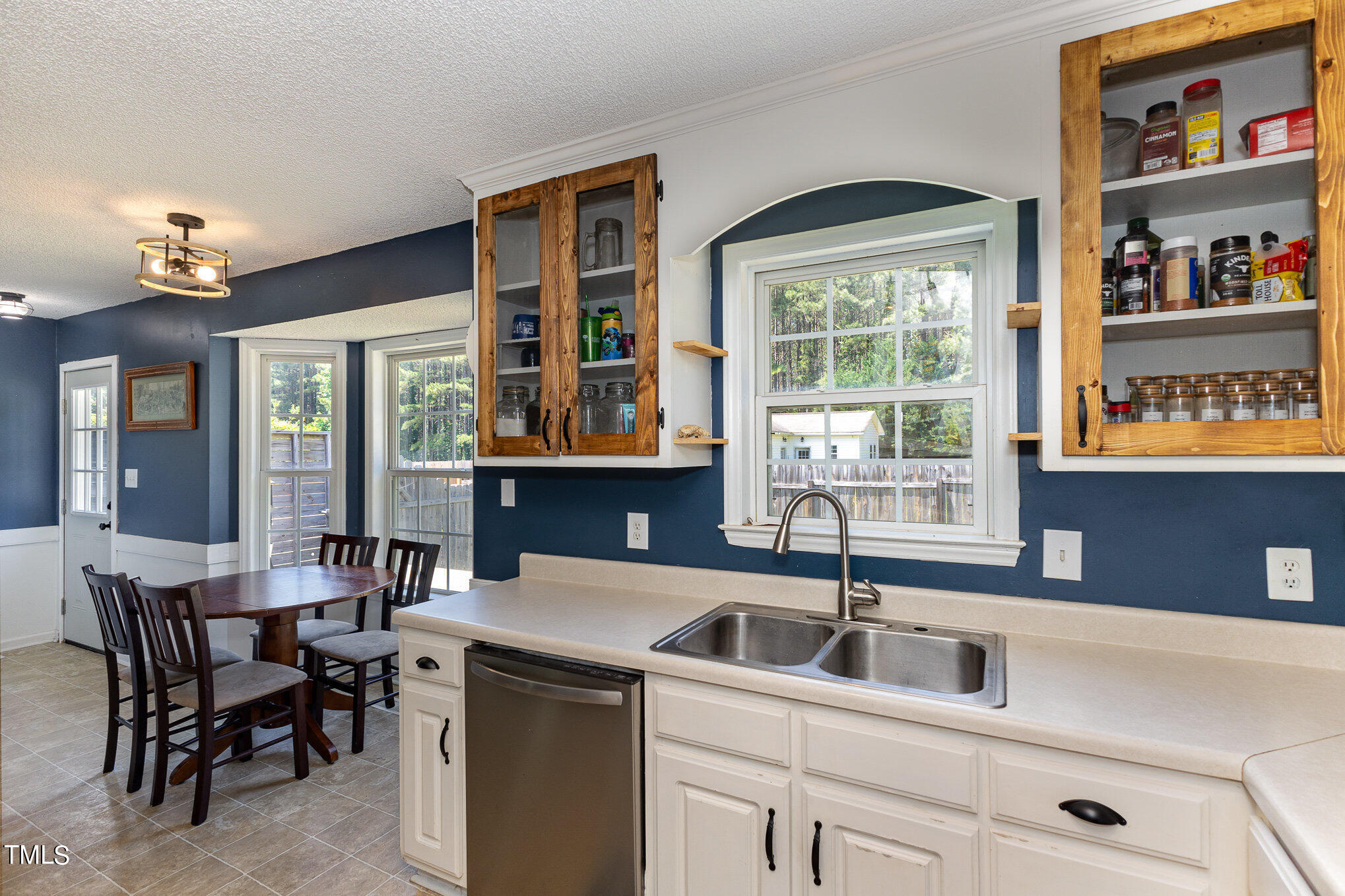 112 Forest Ridge Drive Willow Spring, NC 27592 - Photo 10 of 21 a kitchen that has a sink and chairs in it