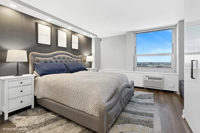 a bedroom with a bed and a large window