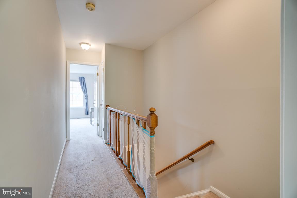 6067 Knights Ridge Way Alexandria, VA 22310 - Photo 18 of 39 a view of a hallway with wooden floor and entryway