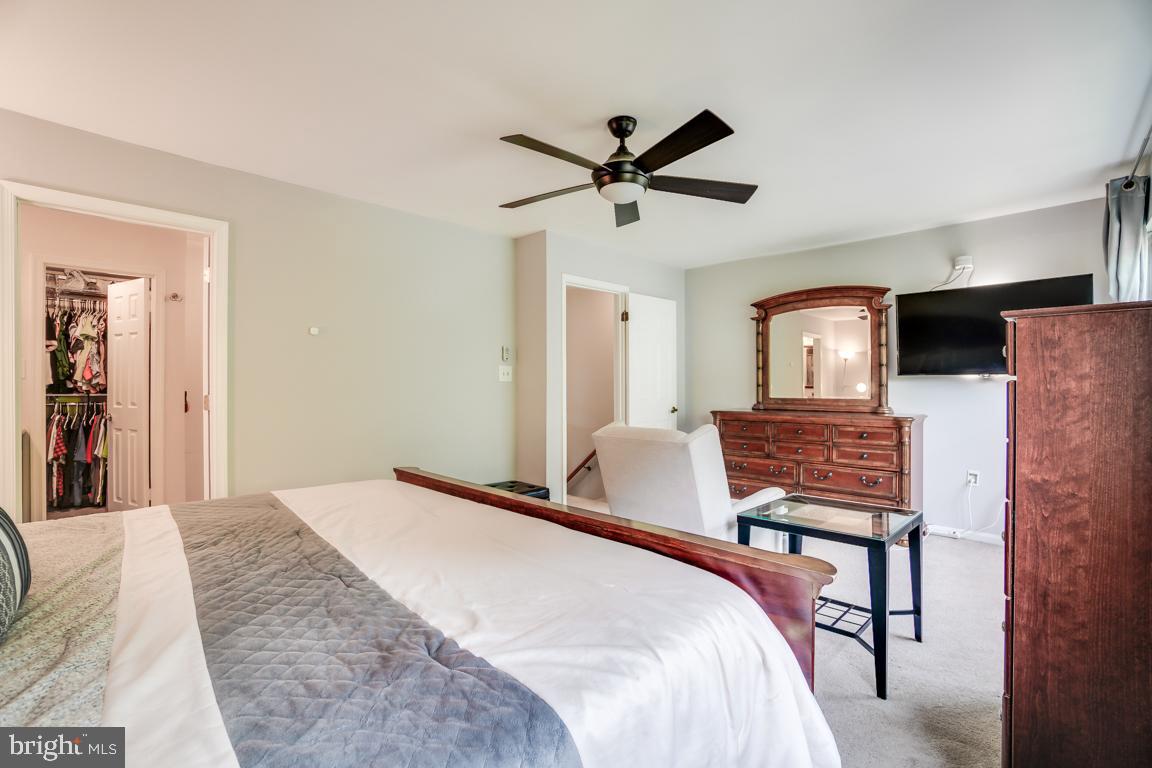 6067 Knights Ridge Way Alexandria, VA 22310 - Photo 25 of 39 a bedroom with a bed and a chandelier