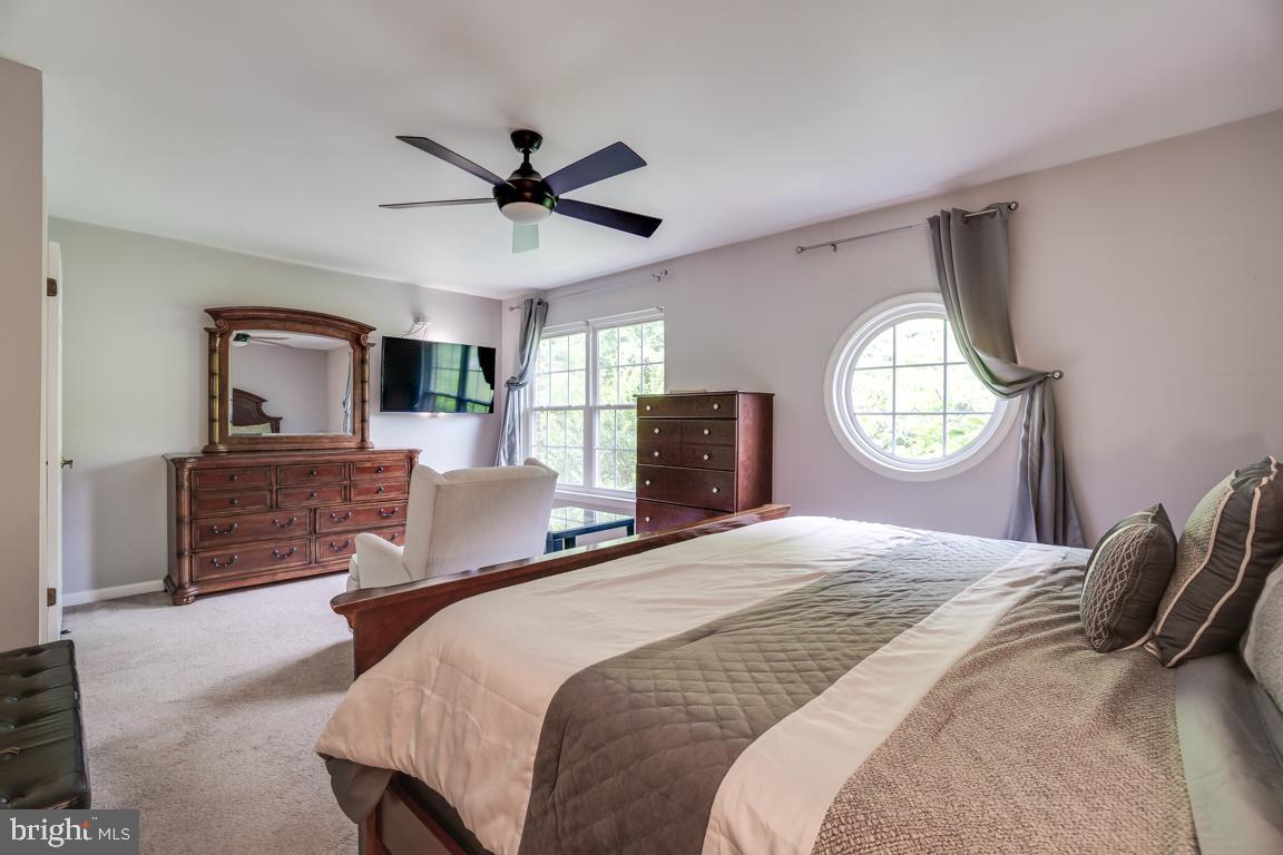 6067 Knights Ridge Way Alexandria, VA 22310 - Photo 26 of 39 a bedroom with a large bed and a chandelier