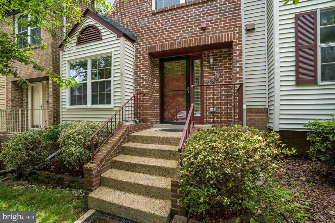6067 Knights Ridge Way Alexandria, VA 22310 - Photo 3 of 39 a front view of a house with a garden