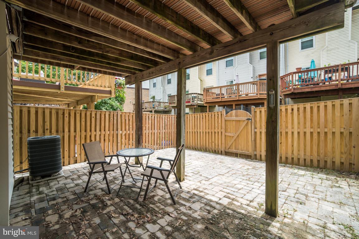 6067 Knights Ridge Way Alexandria, VA 22310 - Photo 36 of 39 a patio with table and chairs