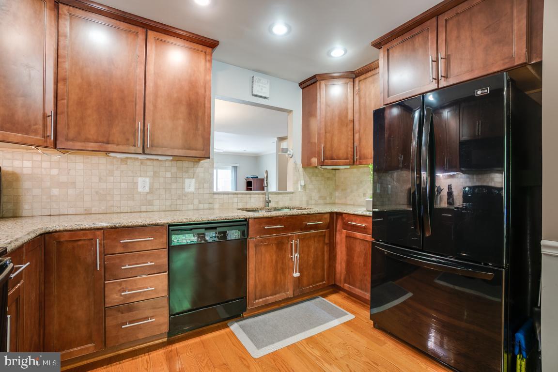 6067 Knights Ridge Way Alexandria, VA 22310 - Photo 9 of 39 a kitchen with granite countertop stainless steel appliances and wooden cabinets