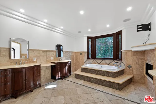 a bathroom with a toilet a sink and a mirror