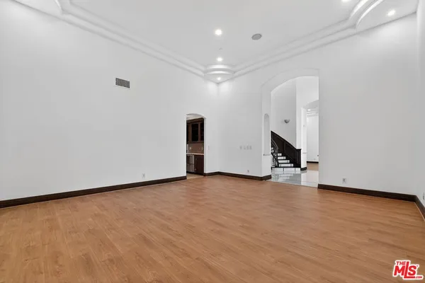 a view of an empty room with wooden floor