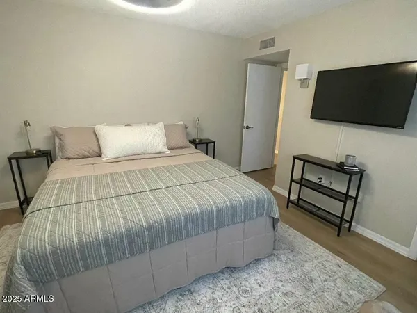 a bedroom with a bed and a flat screen tv
