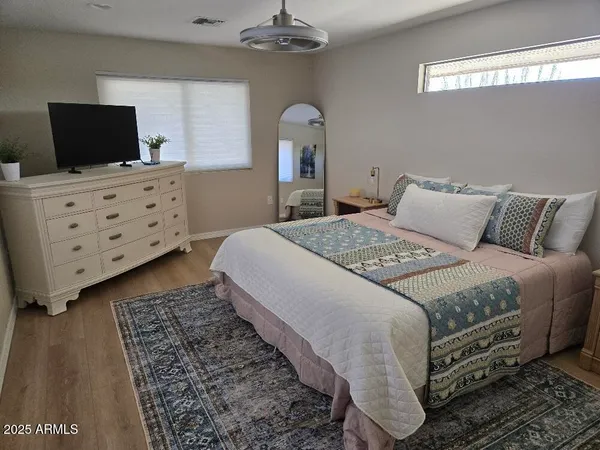 a bedroom with a bed and a flat screen tv