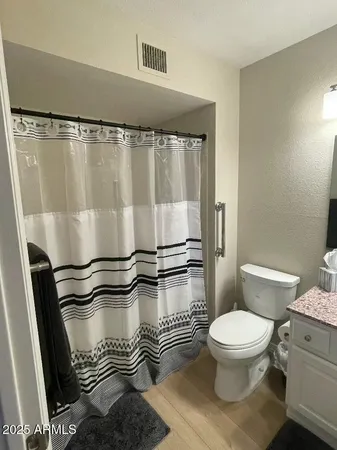 a bathroom with a toilet and a shower