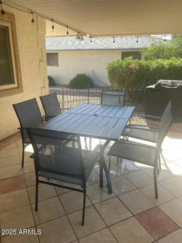 a terrace with outdoor seating and wooden floor
