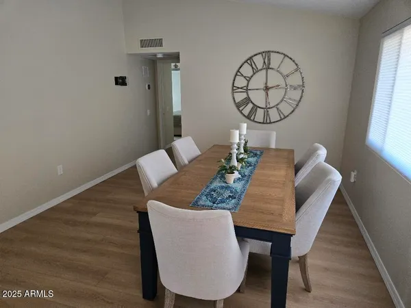 a view of a dining room with furniture and wooden floor