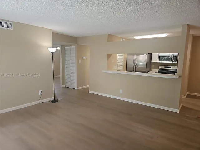 a view of a kitchen cabinets and wooden floor
